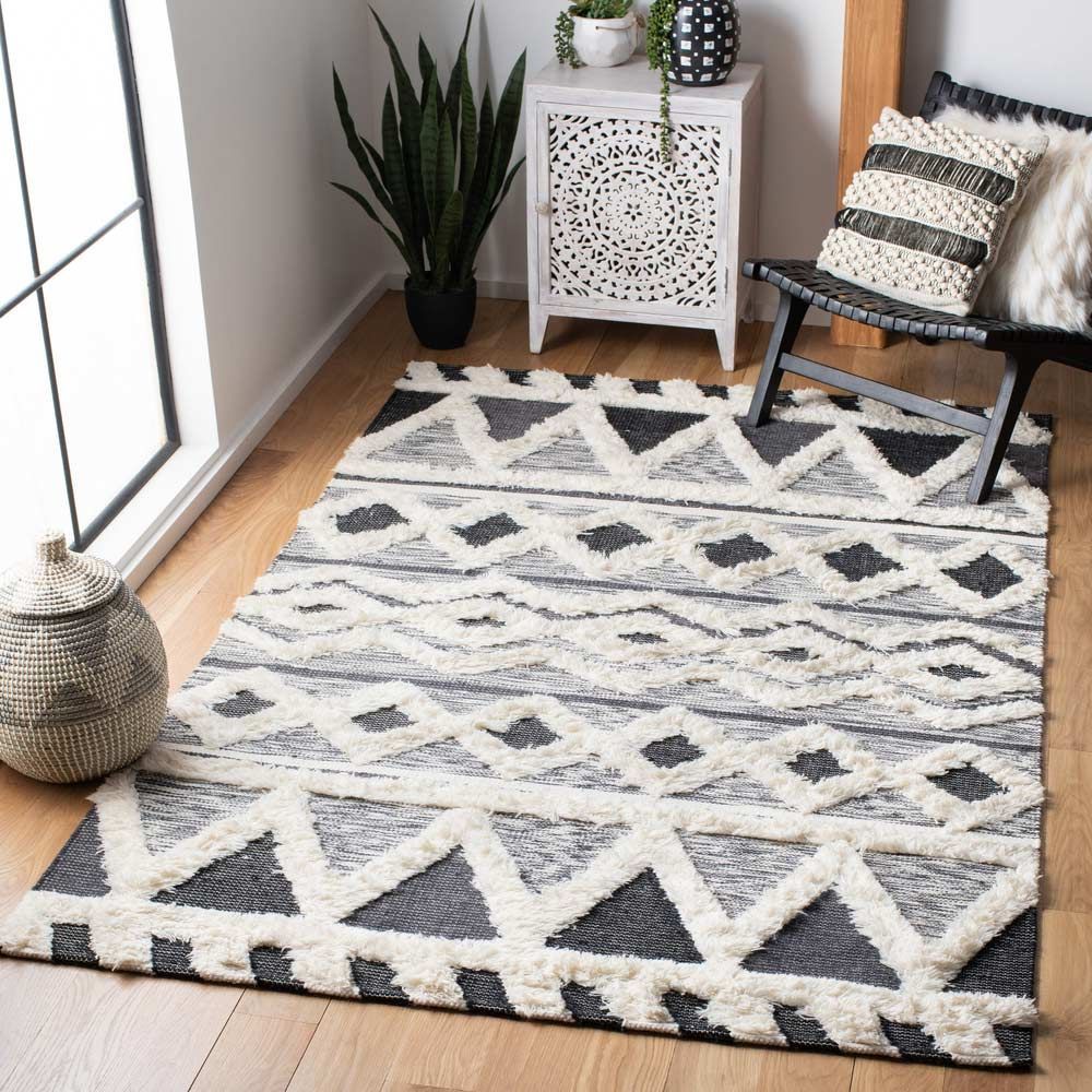 A Black And White Carpet Is Sitting On A Wooden Floor In A Living Room — Affordable Carpets Woolgoolga In Northern Rivers, NSW