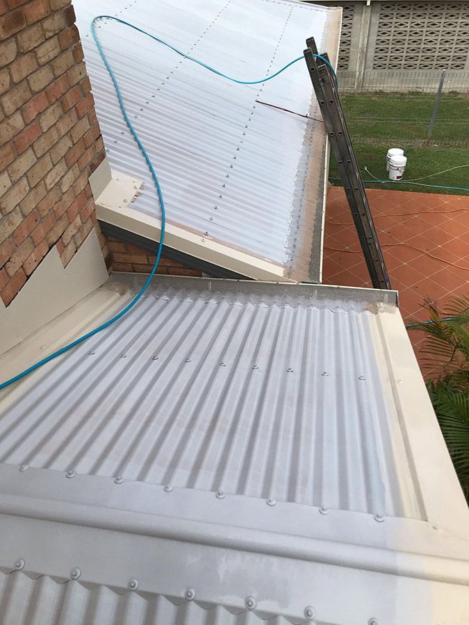 A Close Up of a Roof With a Hose Attached to It — Top Roof NQ in Townsville, QLD
