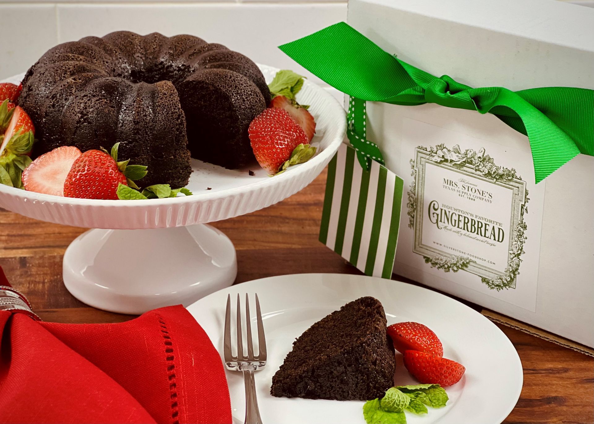 Gingerbread cookie in clear wrapper with label against green and white striped paper.