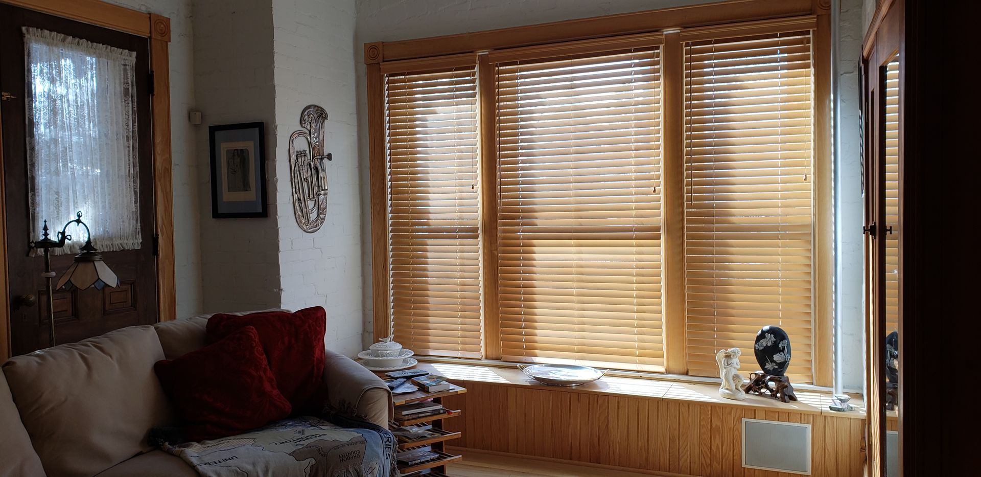 a living room wooden blinds in a living room window