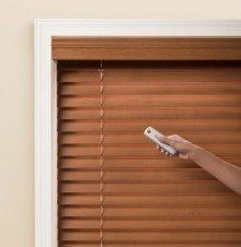 a close up of a wood blinds on a window .