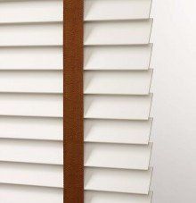 a close up of a white blind with a Solid and decorative tape