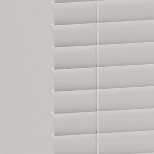 a close up of a white aluminum blind with hidden hole on a window . 