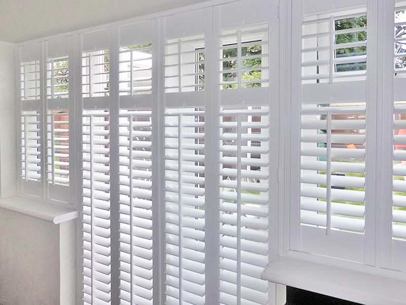 a close up of a window with wooden shutters on it .