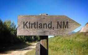 a wooden sign pointing to Kirtland NM