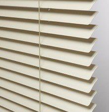 a close up of a lights out slat white blind on a window .