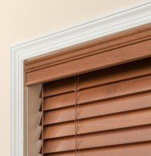 a close up of a wooden blind with a standard decorative valance