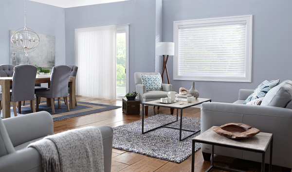 A living room with a couch , chair , coffee table and dining table.