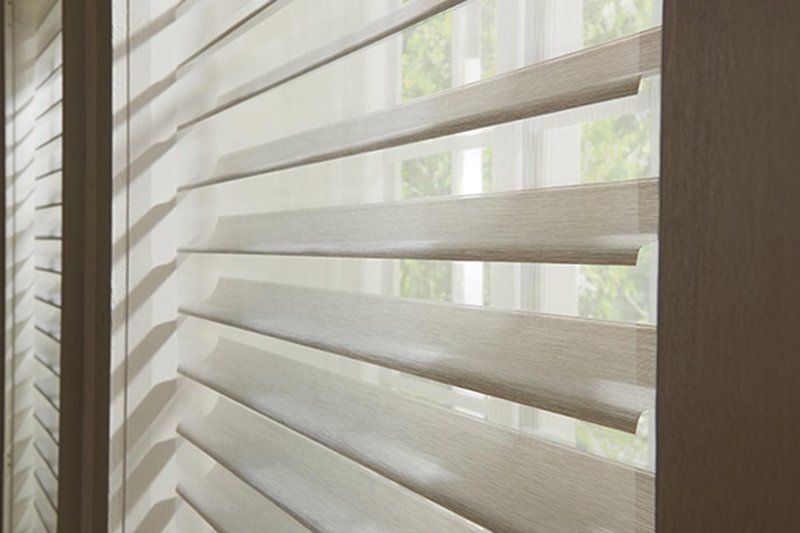 a close up of a window with sheer shades