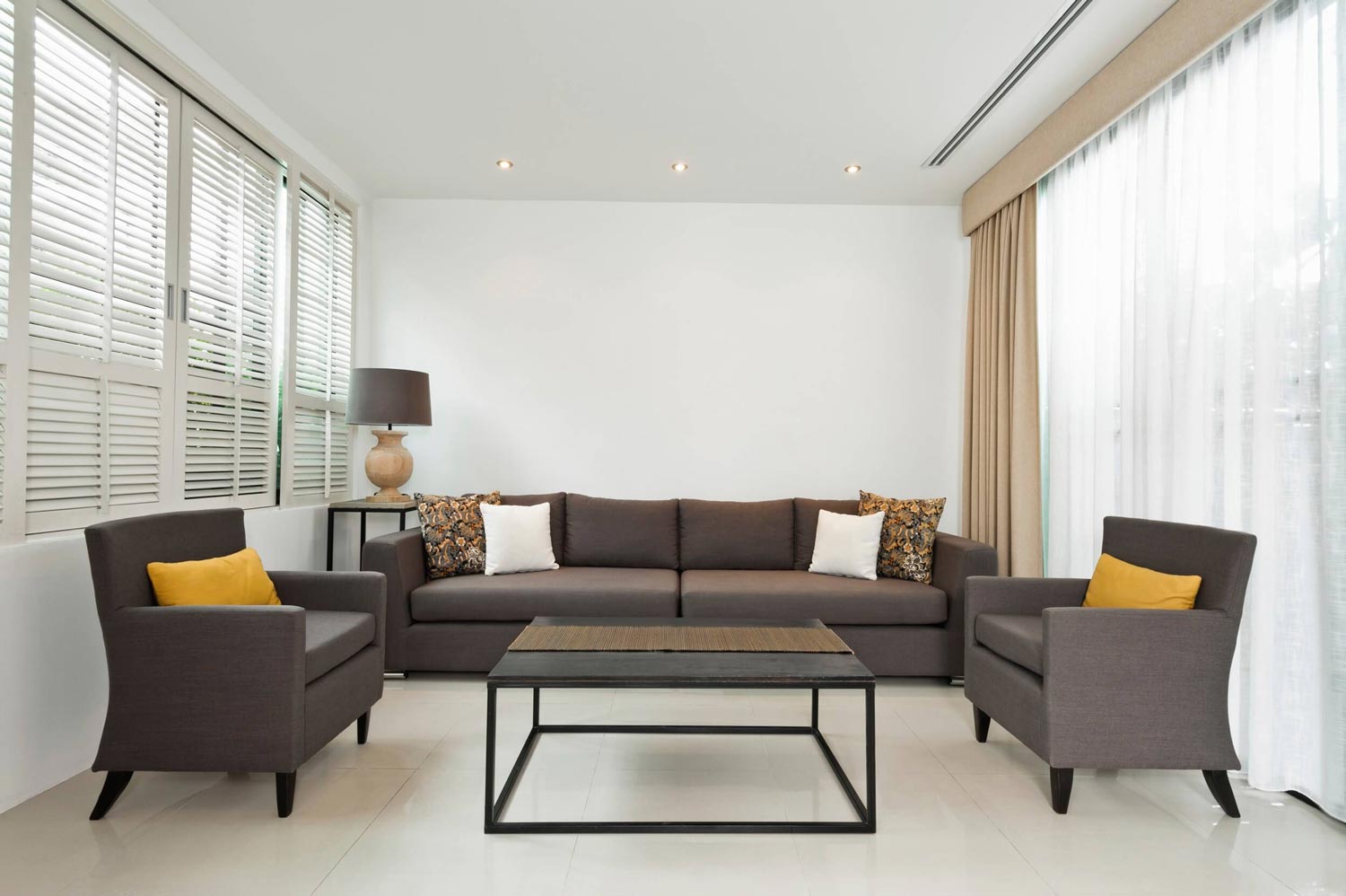 Living room with white shutters installed by Affordable Blind Pros