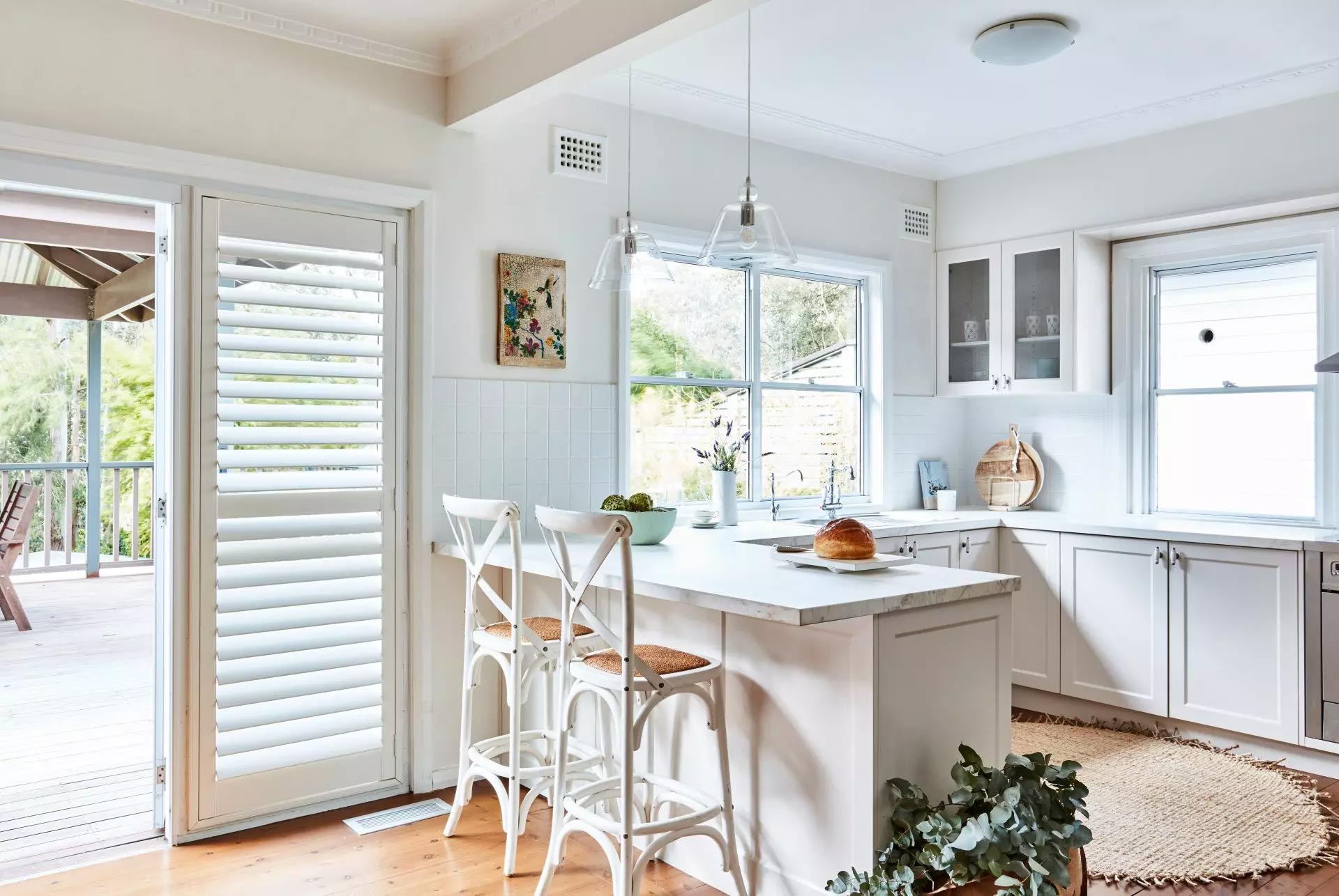 Clean kitchen displaying faux wood shutters