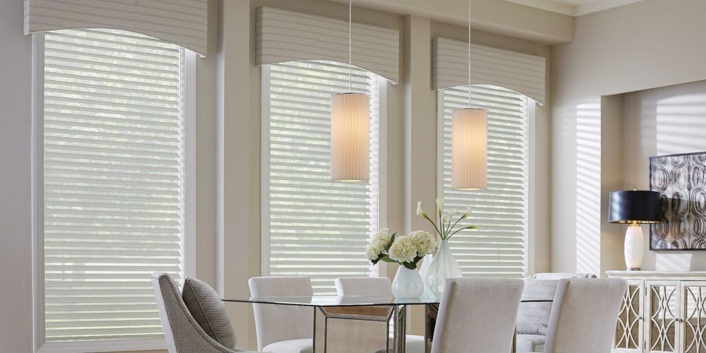 a dining room with a Valances & Cornices wooden blinds