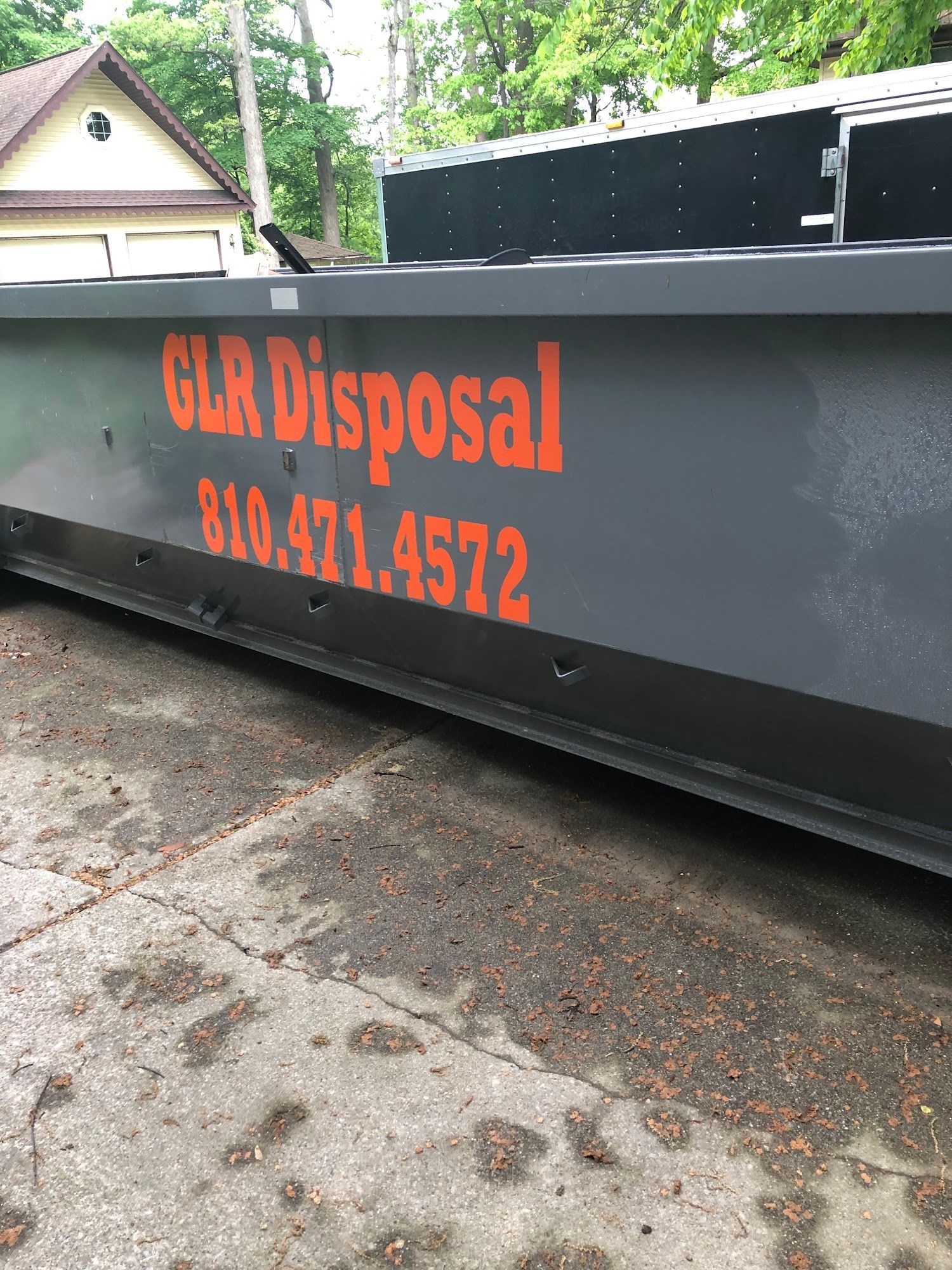 A large, gray metal dumpster with 