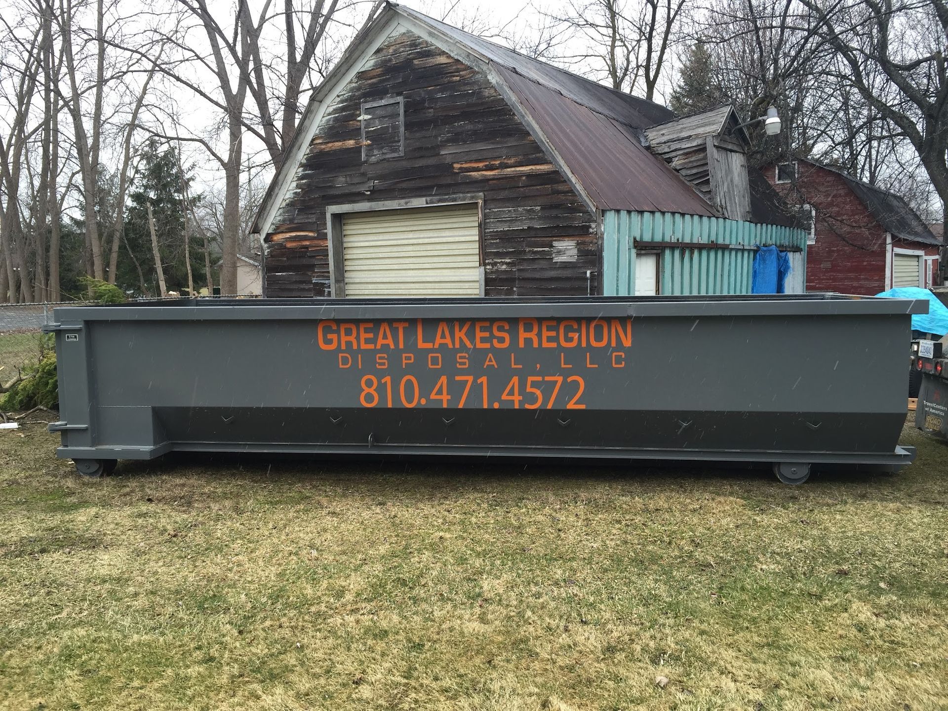 A grey dumpster marked 