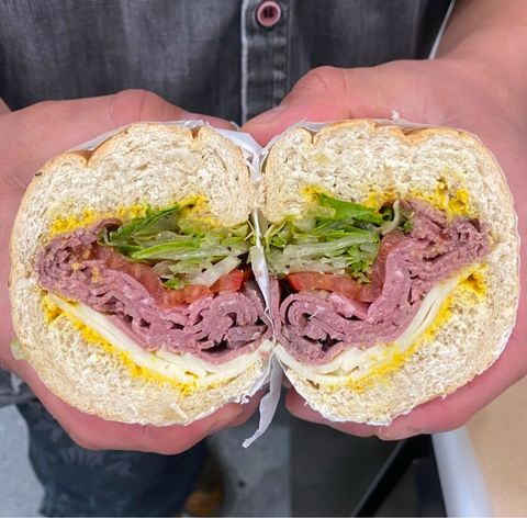 Close-up of Italian deli sandwich with meats, cheese, and fresh toppings