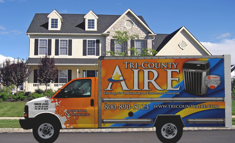 Tri-County Aire service truck parked in front of a two-story Southern Maryland home