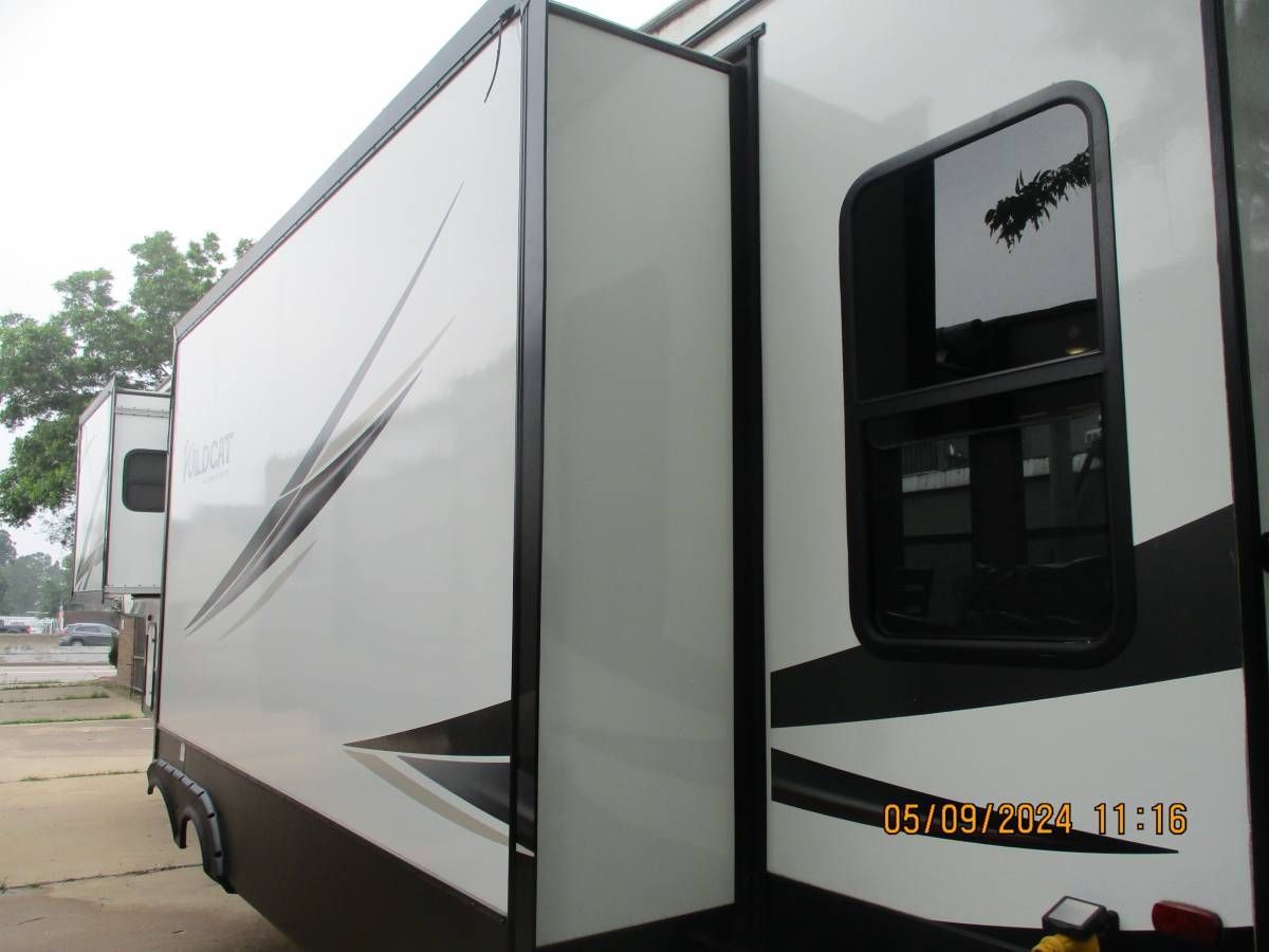 A white trailer is parked in a parking lot
