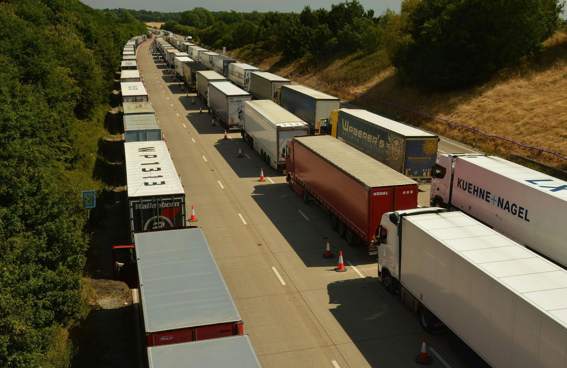 A bunch of trucks are lined up on the side of the road