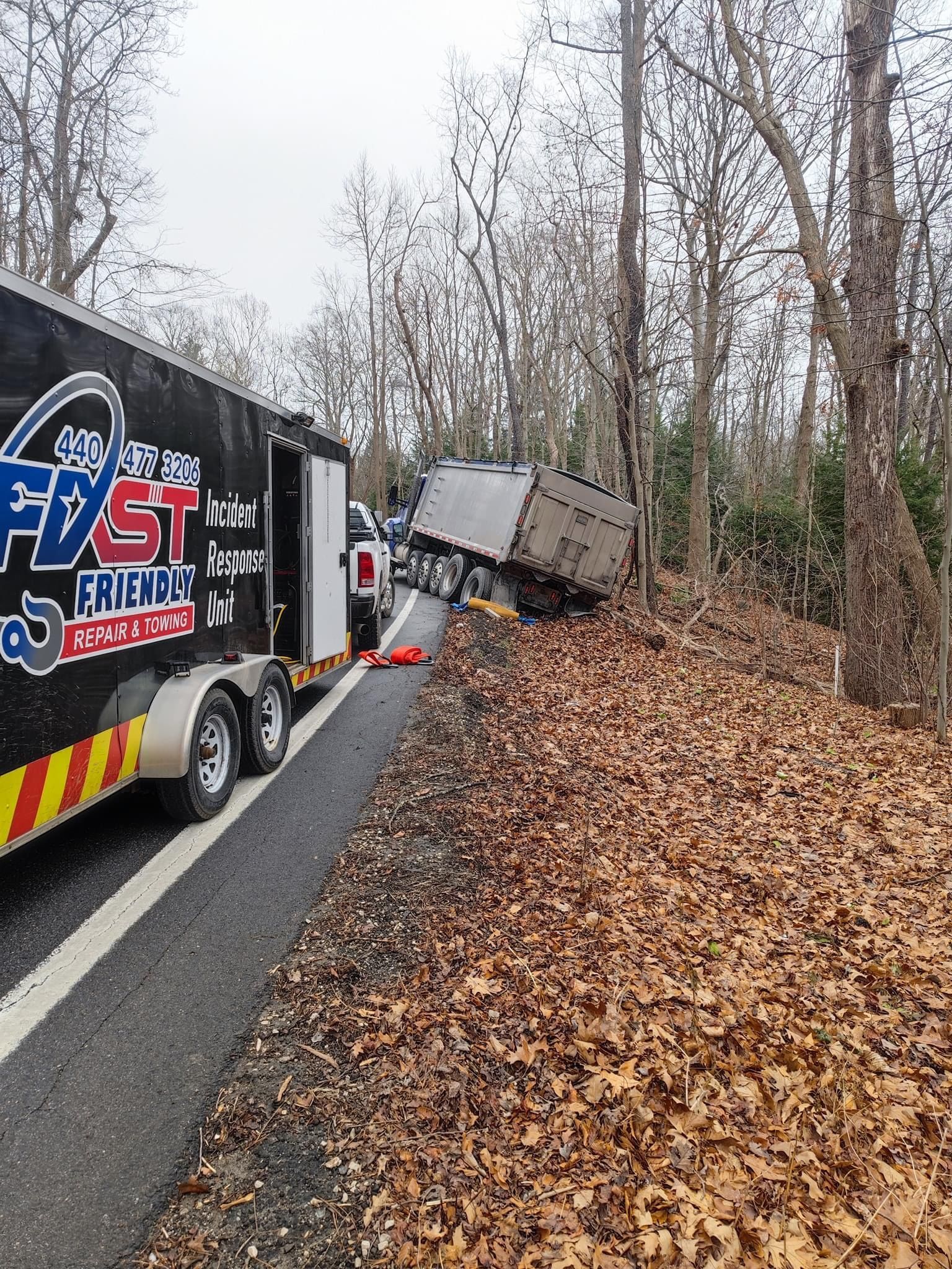A trailer is sitting off the side of a being recovered.
