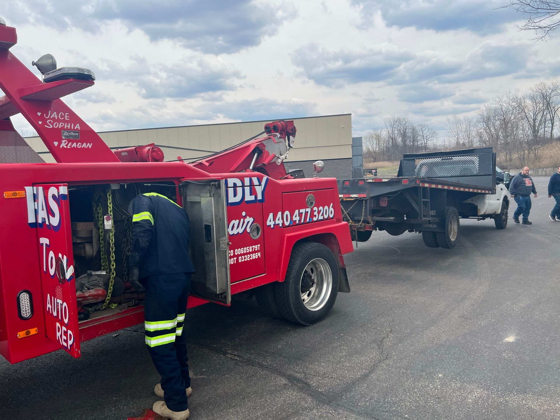 A red tow truck with doors open.