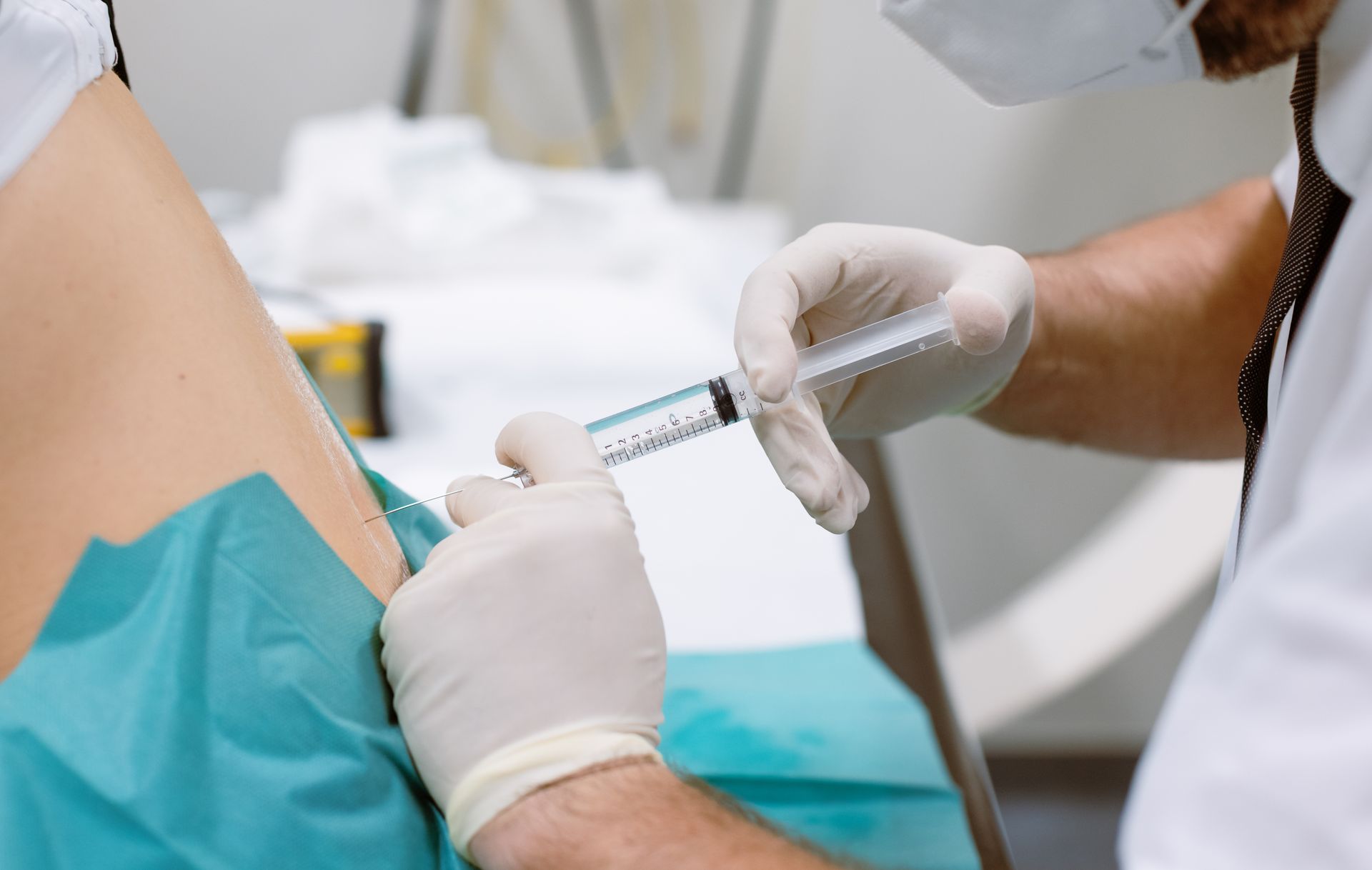 A doctor is giving an injection to a patient.