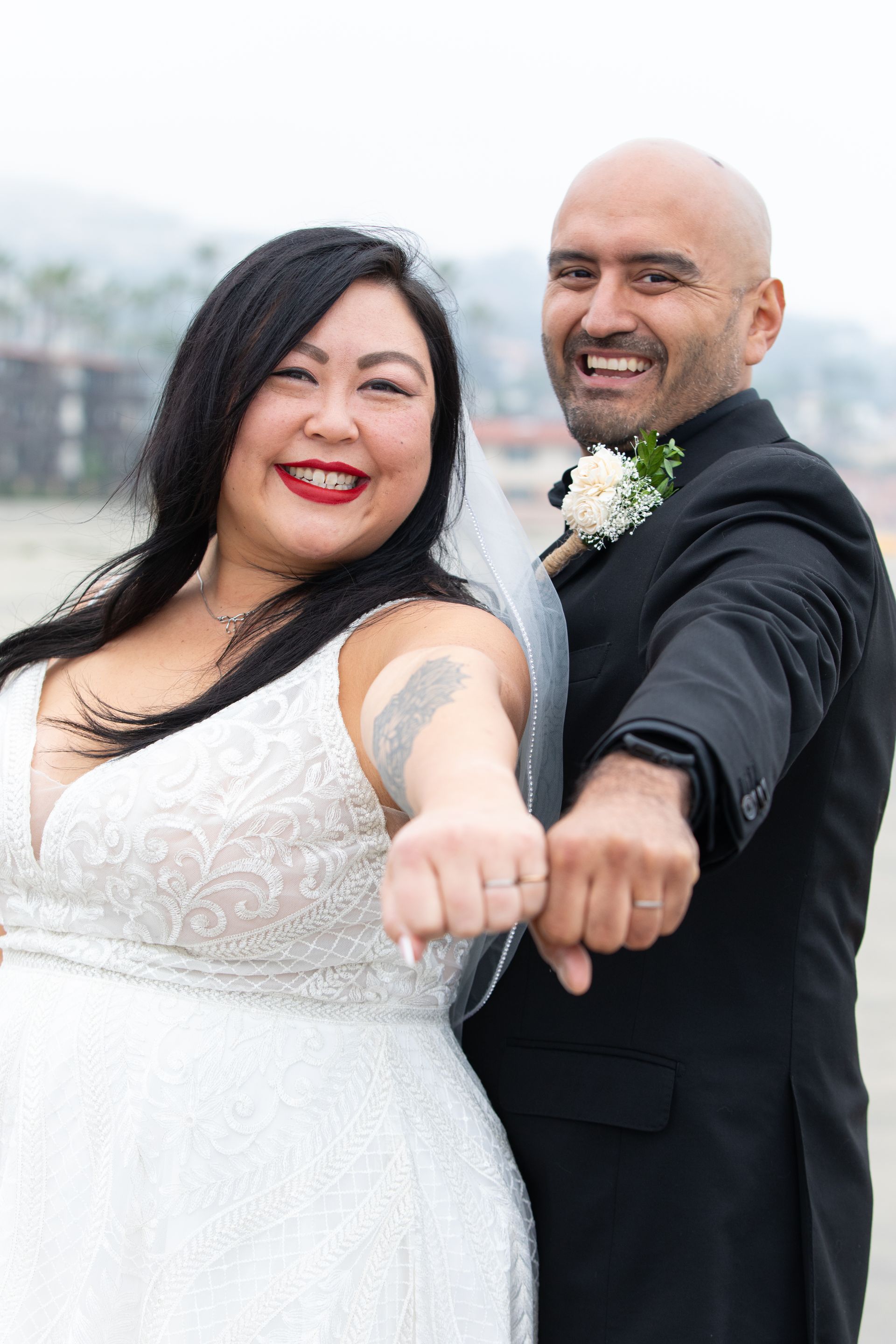 Bride and groom showing off their new wedding bands.