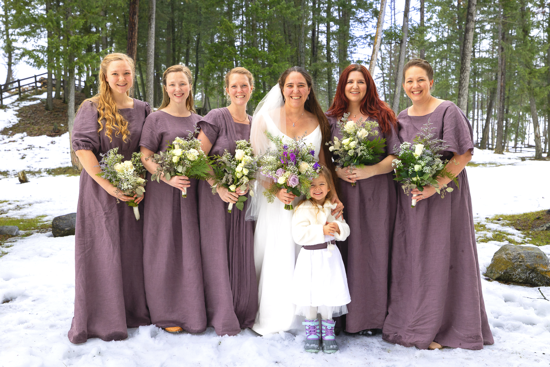 Bride and her bridesmaid posing in the woods