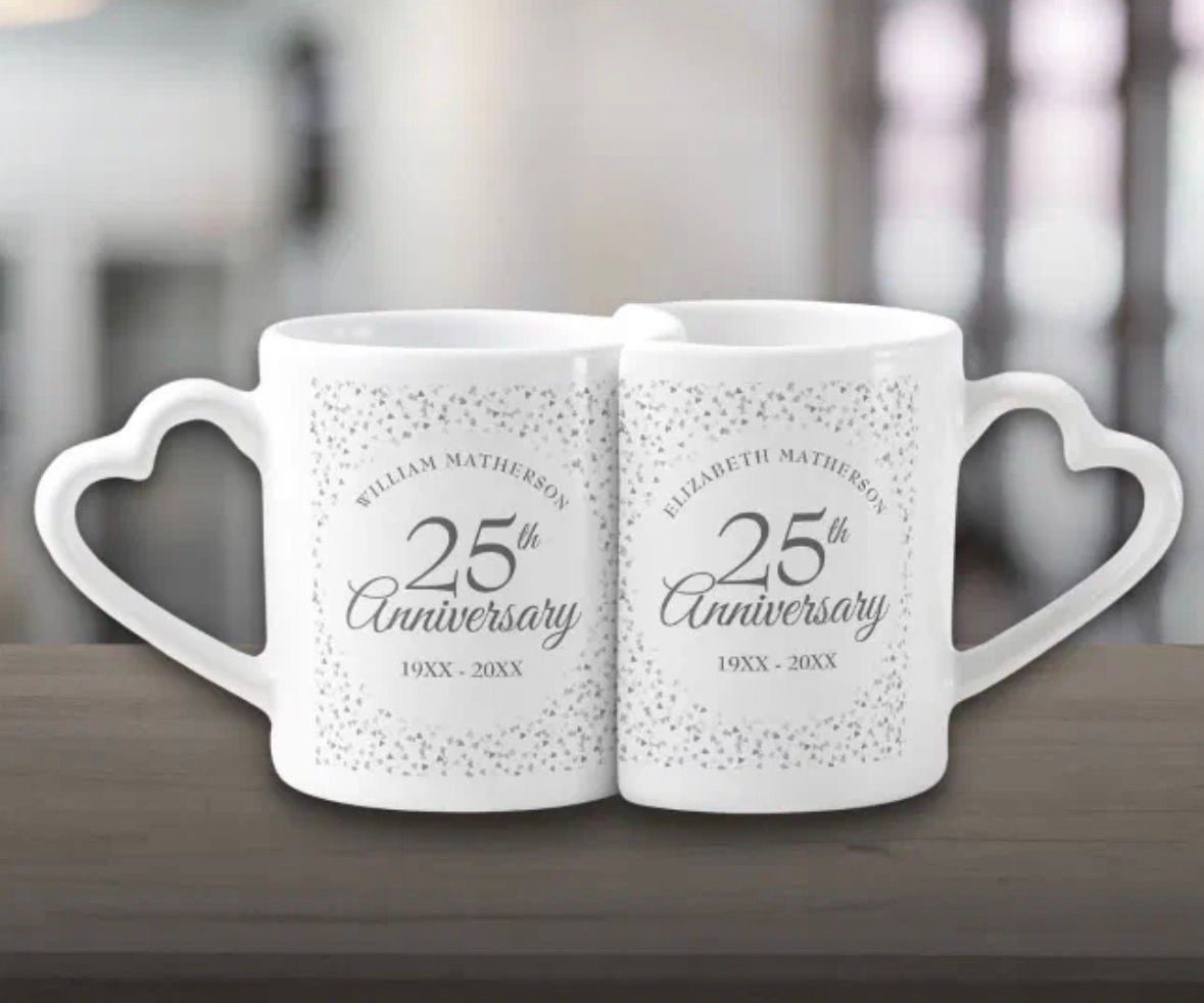 Two white mugs with heart-shaped handles. 