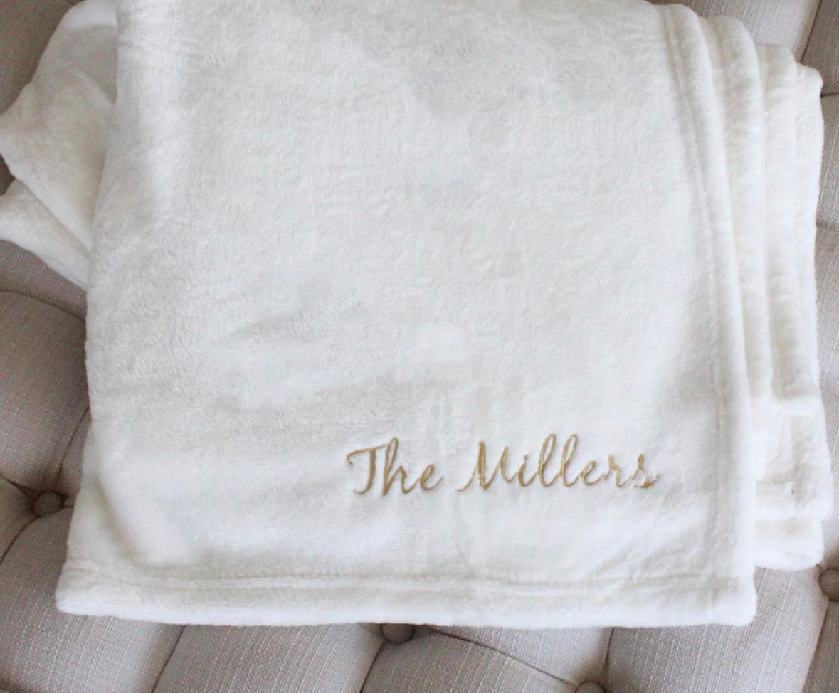 Cream-colored plush blanket embroidered with 