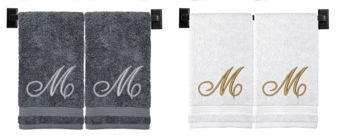 Two pairs of personalized hand towels, one gray and one white, each with the letter 
