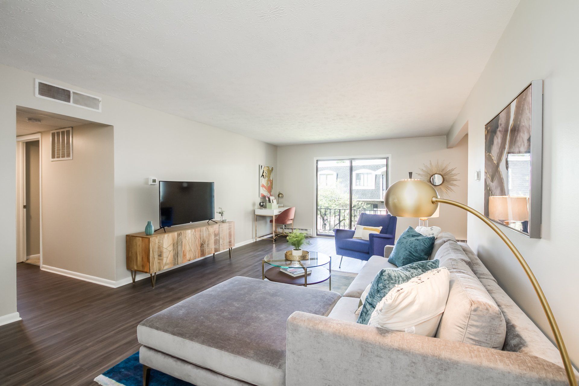 Large living room with sleek flooring and private balcony 