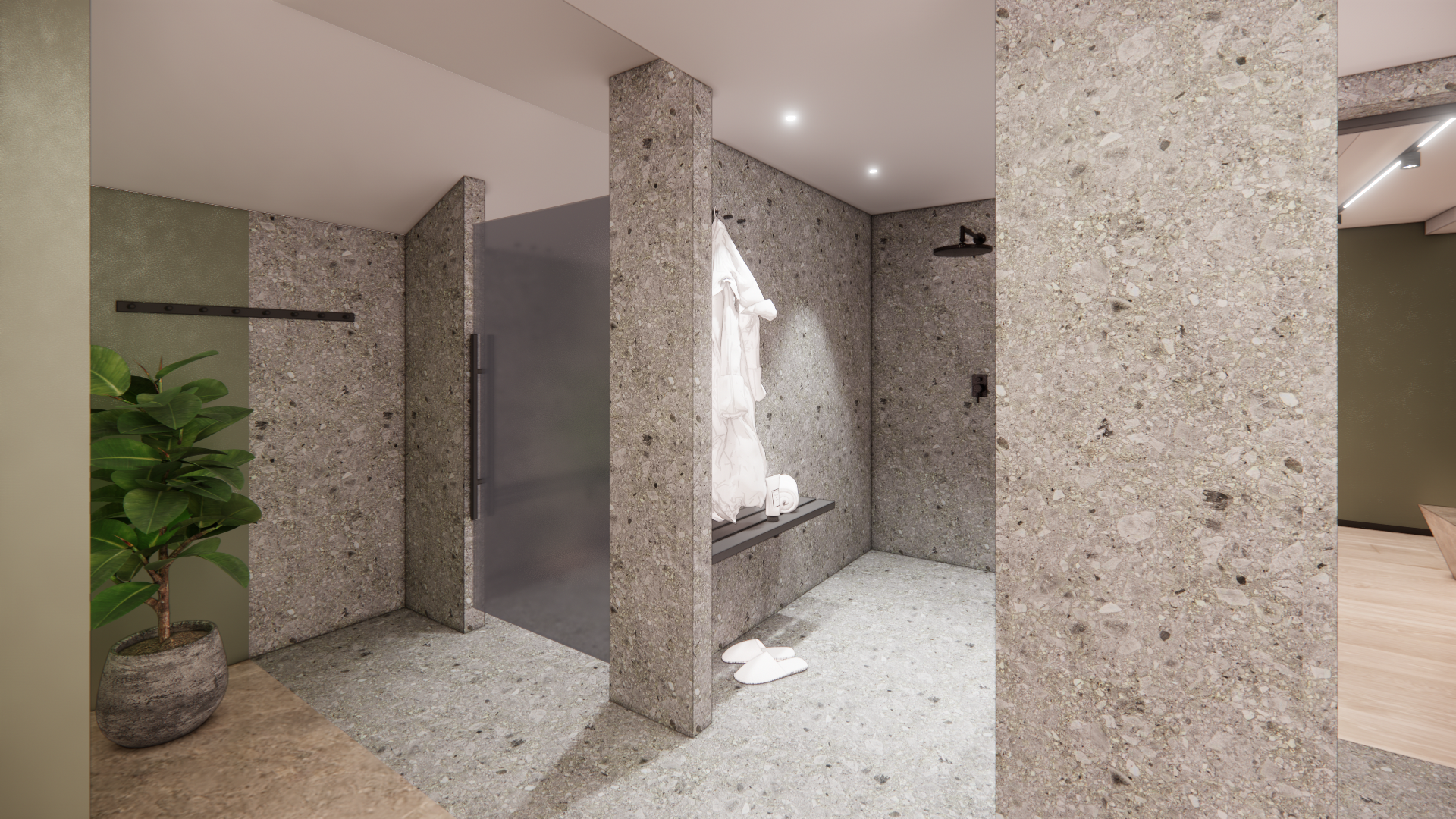 Modern openbaar toilet met gespikkelde stenen muren, wastafels, spiegels en een potplant.