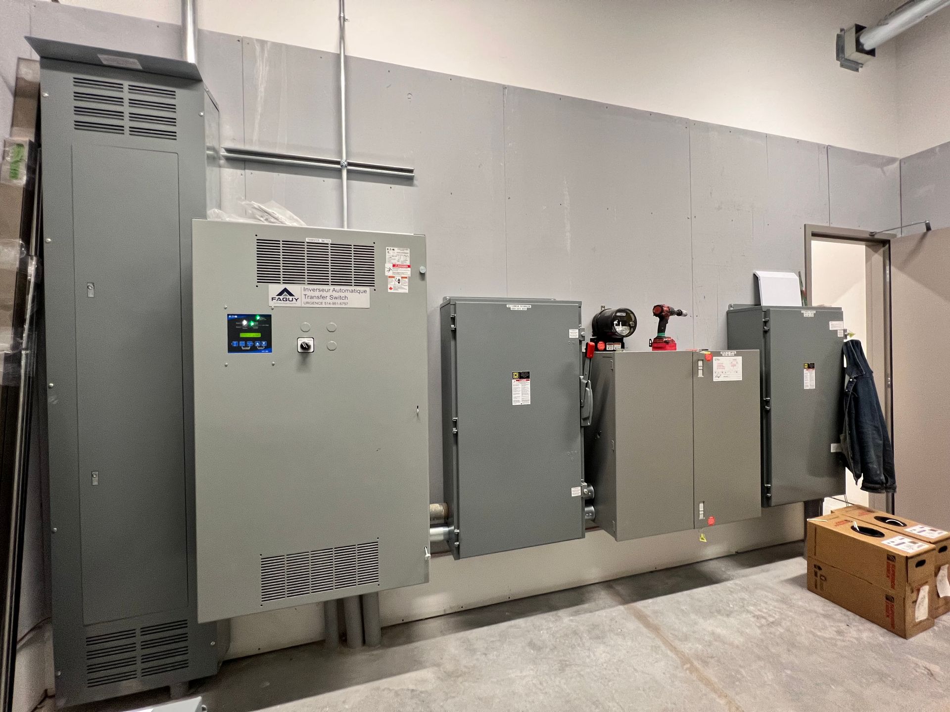 Une pièce avec beaucoup de boîtes électriques sur le mur.