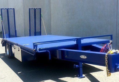 A Beautiful Blue Trailer Is Parked in Front of A Concrete Wall — Welshpool, WA — PTE Group Pty Ltd