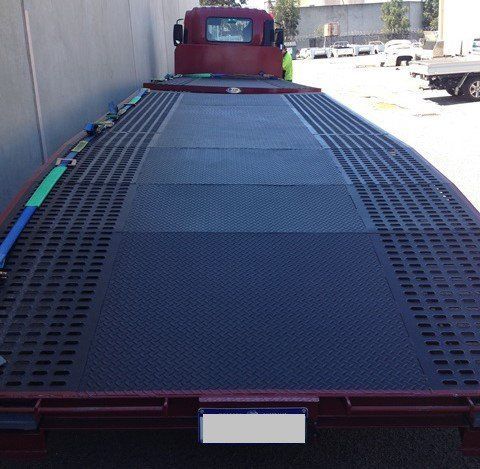 A Tow Truck with A Flat Bed Is Parked in A Parking Lot — Welshpool, WA — PTE Group Pty Ltd