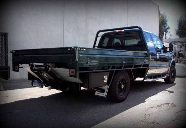 Black Truck with A Flat Bed Is Parked in Front of A Building — Welshpool, WA — PTE Group Pty Ltd