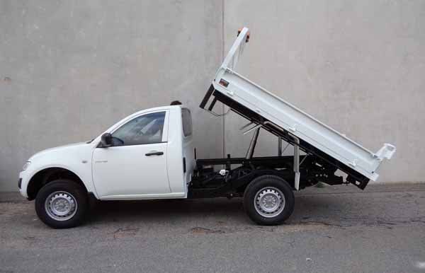A White Dump Truck Is Parked in Front of A Concrete Wall — Welshpool, WA — PTE Group Pty Ltd
