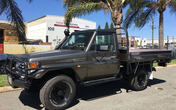 A Toyota Land Cruiser with A Tray Bed Is Parked on The Side of The Road — Welshpool, WA — PTE Group Pty Ltd