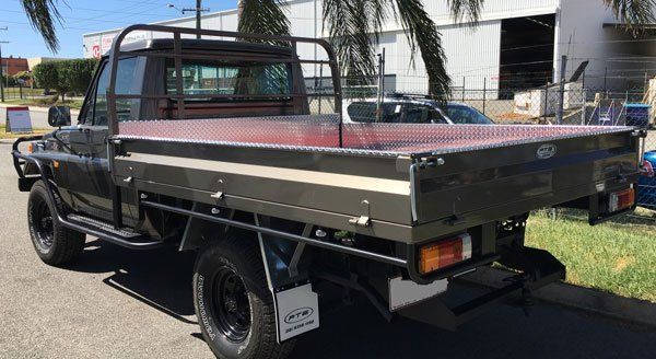A Black Truck with A Tray on The Back Is Parked on The Side of The Road — Welshpool, WA — PTE Group Pty Ltd