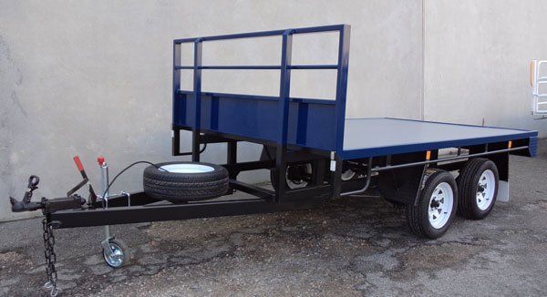 A Blue and Black Flatbed Trailer Is Parked in Front of A Building — Welshpool, WA — PTE Group Pty Ltd