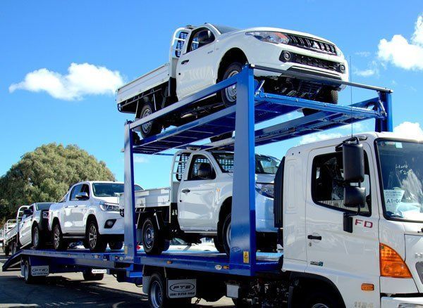 A Truck Is Carrying a Stack of Cars on Top of Each Other — Welshpool, WA — PTE Group Pty Ltd