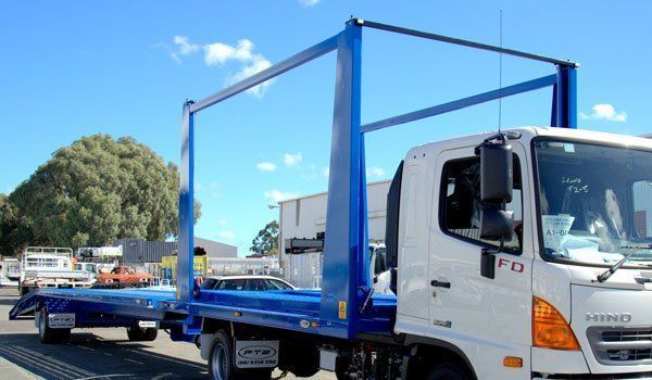 A White Truck with A Blue Trailer Attached to It Is Parked on The Side of The Road — Welshpool, WA — PTE Group Pty Ltd