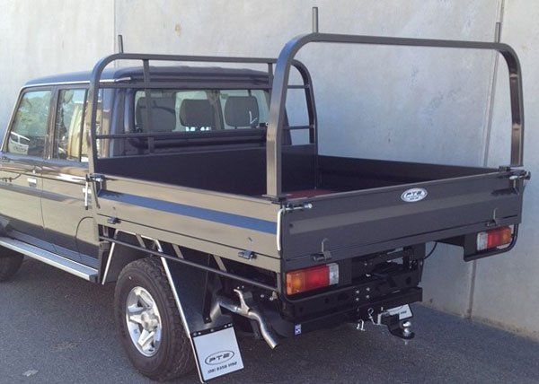 A Beautiful Big Black Truck with A Tray on The Back Is Parked in Front of A Concrete Wall — Welshpool, WA — PTE Group Pty Ltd