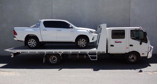 A White Truck Is Sitting on Top of A Flatbed Tow Truck — Welshpool, WA — PTE Group Pty Ltd