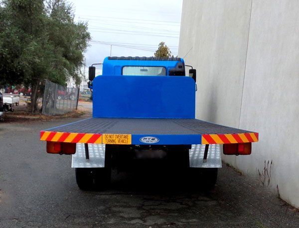 A Blue Tow Truck Is Parked in Front of A Building — Welshpool, WA — PTE Group Pty Ltd