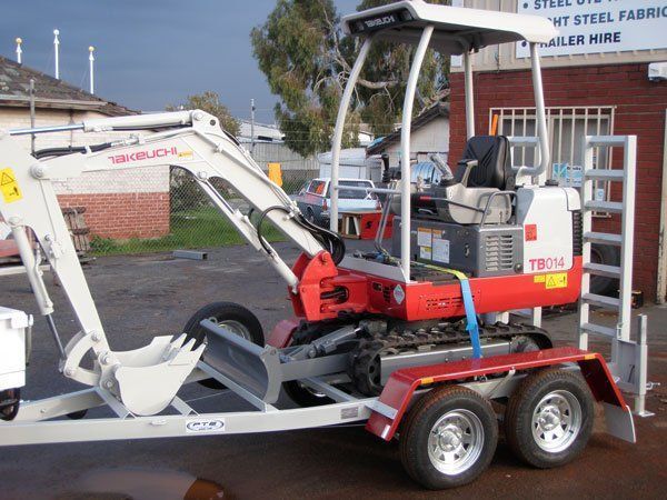 A Small Excavator Is Sitting on Top of A Trailer — Welshpool, WA — PTE Group Pty Ltd