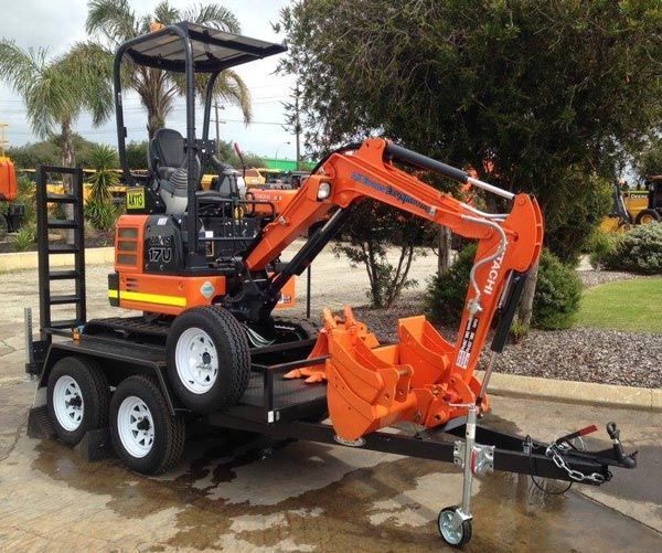 A Beautiful Small Orange Excavator Is Parked on A Trailer — Welshpool, WA — PTE Group Pty Ltd