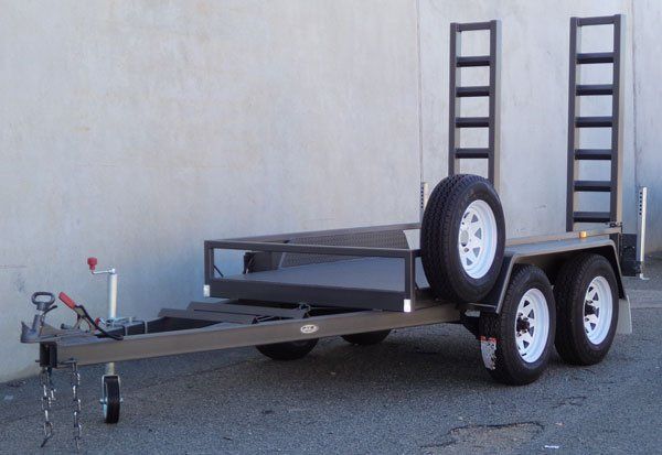A Trailer with A Ramp on The Back Is Parked in Front of A Building — Welshpool, WA — PTE Group Pty Ltd