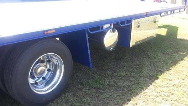 A Blue Flatbed Tow Truck Is Parked in The Grass — Welshpool, WA — PTE Group Pty Ltd
