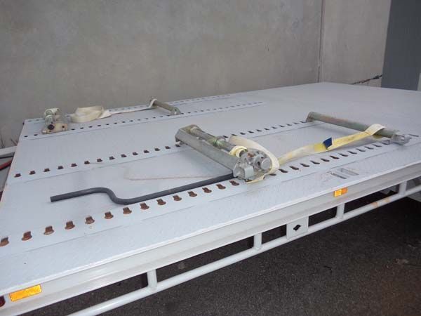 A White Trailer with A Sling Attached to It Is Parked in Front of A Building — Welshpool, WA — PTE Group Pty Ltd